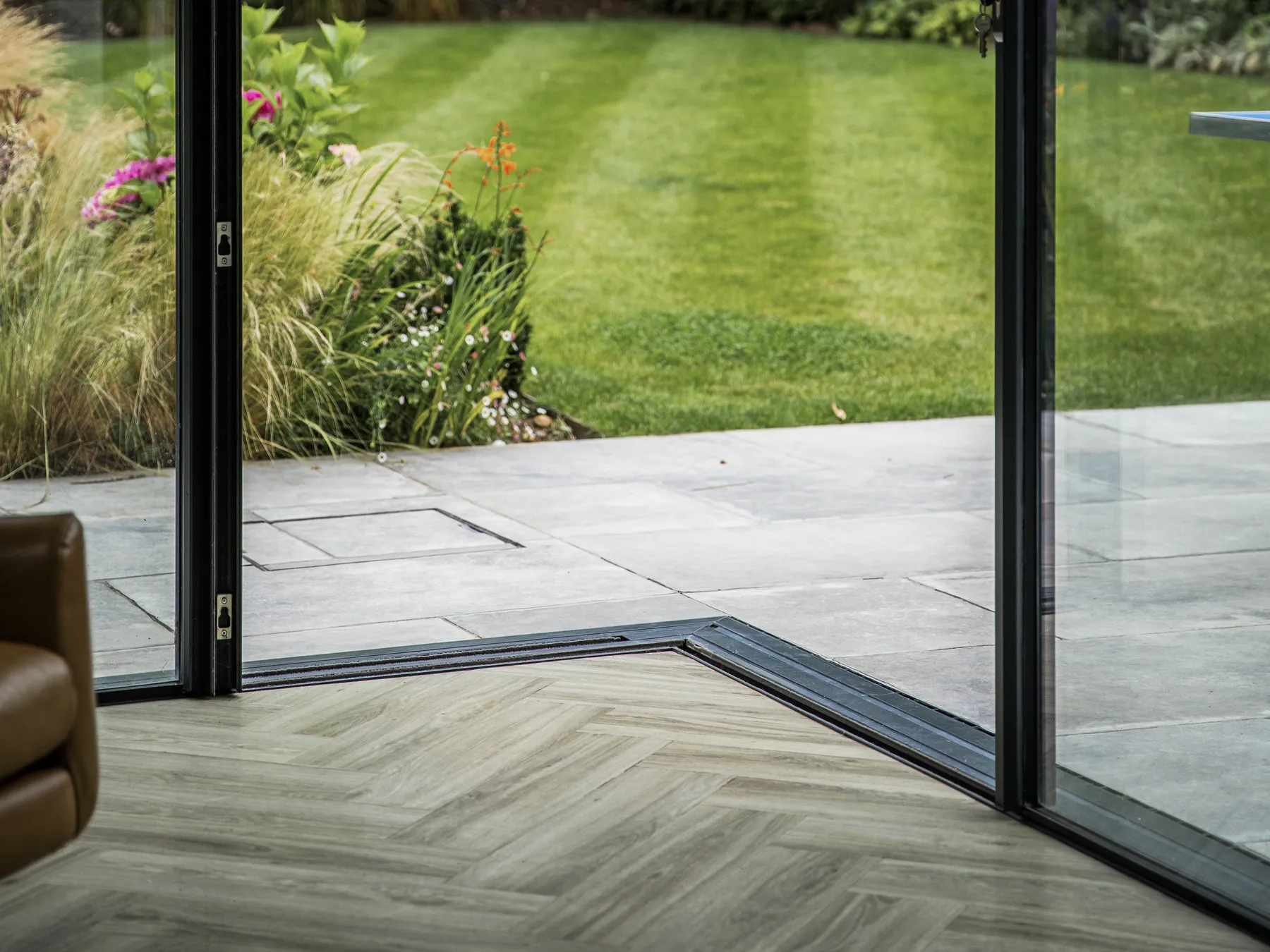 Sliding doors open flush to the lawn