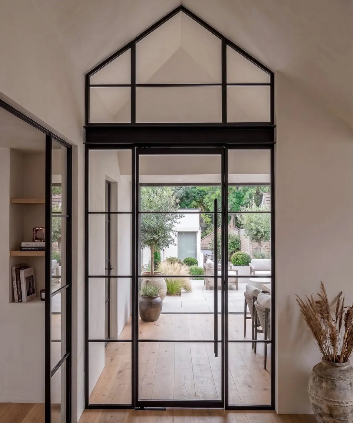 Steel Crittall-style doors under a gable